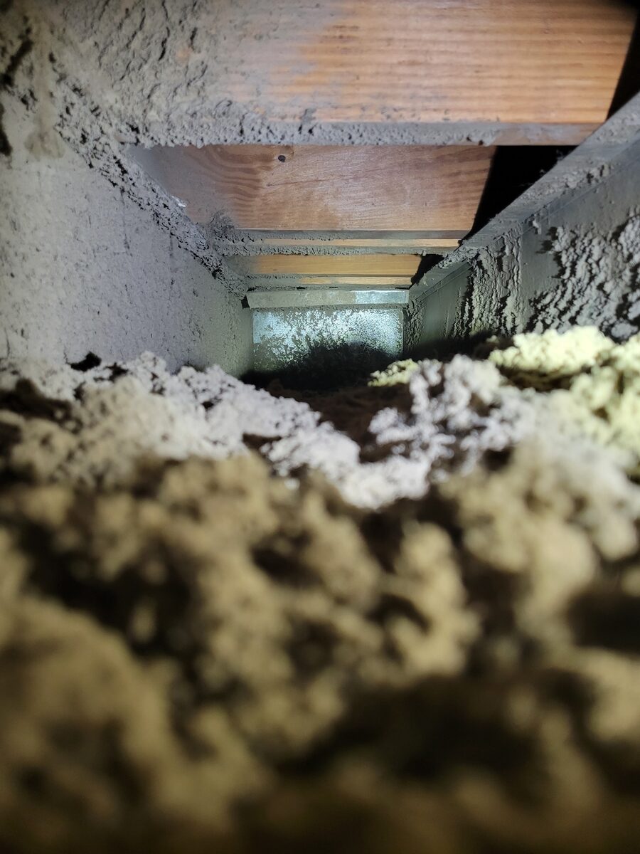 Duct walls furred all over with thick built-up dust before cleaning